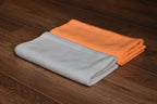KHEMIA PLUS Pearl edgeless pearl weave microfiber towel close-up showing low-pile texture - orange and ice grey colors stacked