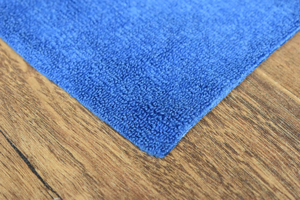 The Daily royal blue microfiber towel close-up showing terry weave texture and edgeless edge