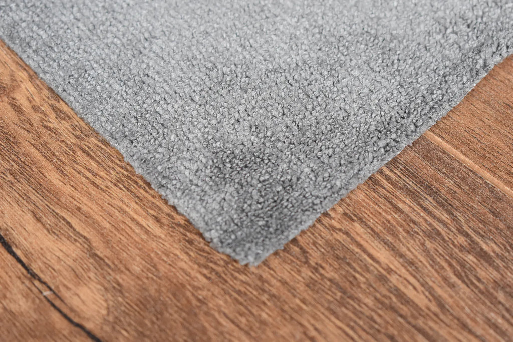 The Daily dark grey microfiber towel close-up showing terry weave texture and edgeless edge