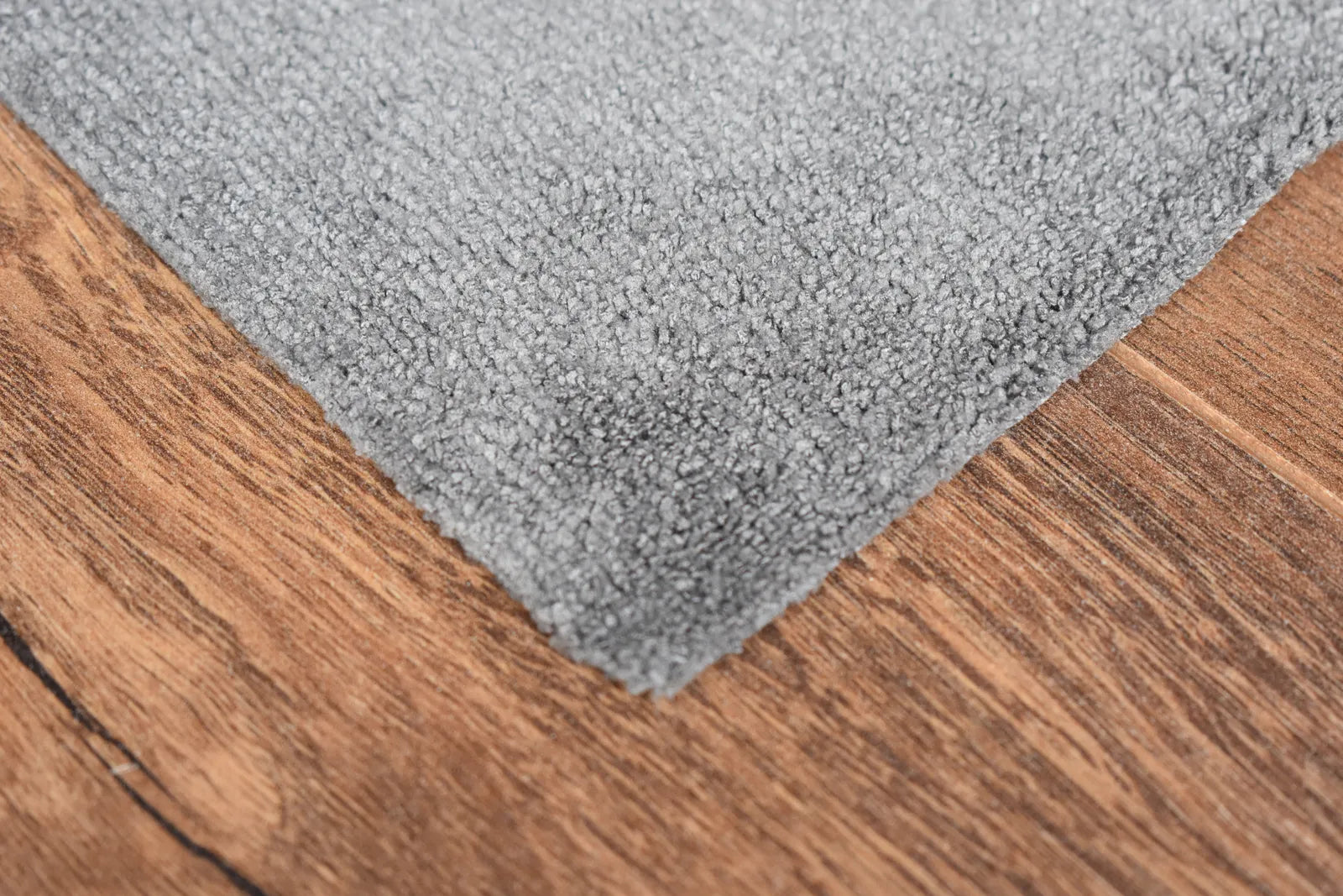 The Daily dark grey microfiber towel close-up showing terry weave texture and edgeless edge