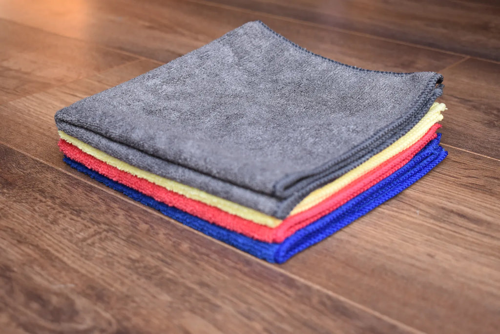 KHEMIA PLUS microfiber cleaning towels for home surfaces stacked - blue, yellow, grey, and magenta color options for color-coded cleaning