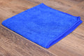 Blue microfiber cleaning towel folded - 300 GSM, 80/20 blend, 35x35 cm, stitched edge for home use