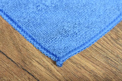 Antibacterial microfiber towel close-up showing terry weave texture and stitched edge construction - tested for home and hospitality use