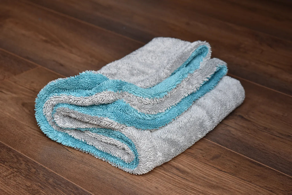 DRY-1100 light grey side laid flat with aqua blue edge visible underneath - dual-layer twist-loop construction