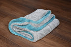 DRY-1100 light grey side laid flat with aqua blue edge visible underneath - dual-layer twist-loop construction