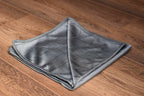 Carbon Glass towel edge detail showing precision-stitched rounded corners and microfiber weave texture