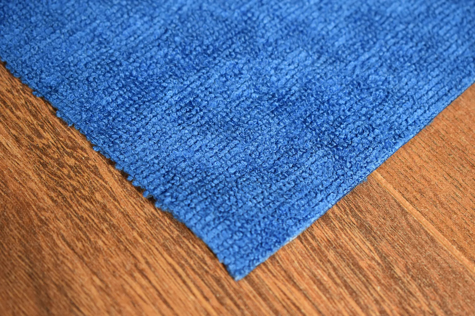 Light Terry blue microfiber towel close-up showing terry weave texture and edgeless edge